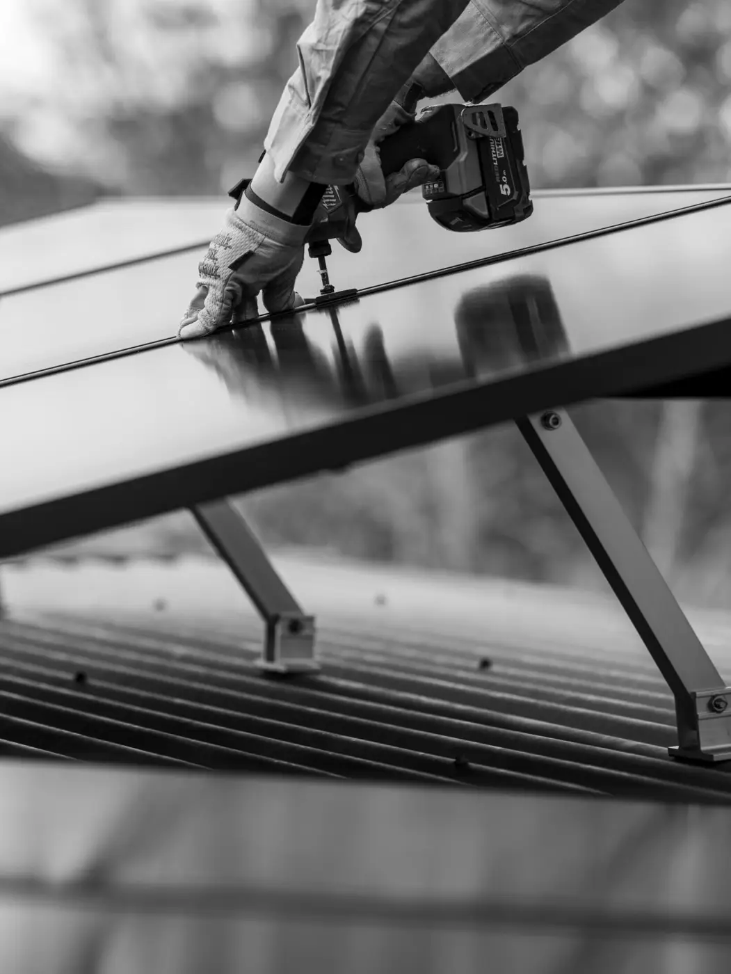Newy Solar Co installer carrying a solar panel on a Glen William roof