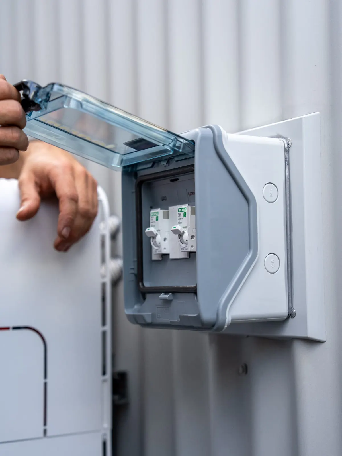 Newy Solar Co electrician checking a battery isolator at a Mayfield installation