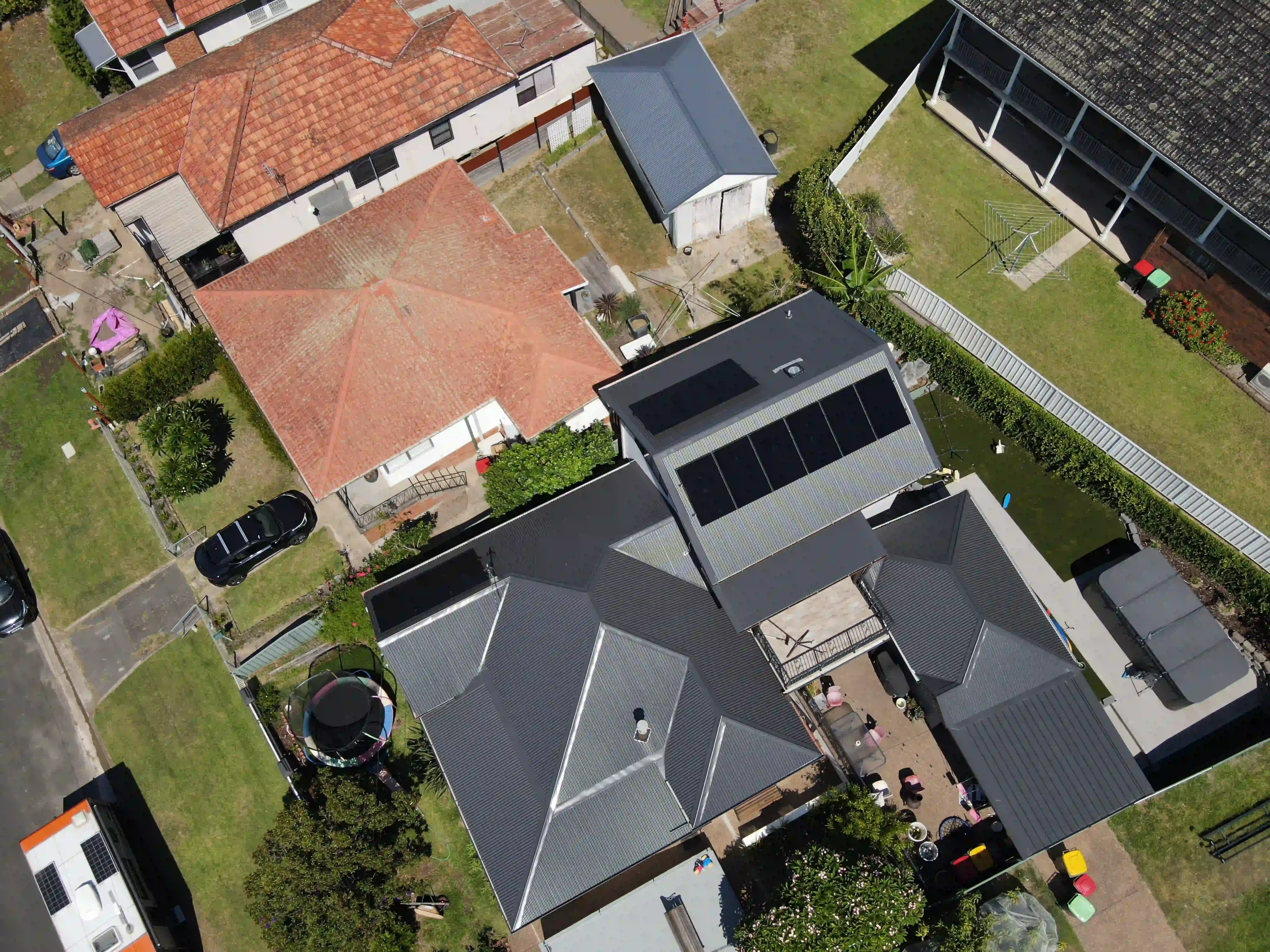 Aerial view of solar panels across a New Lambton roof and backyard