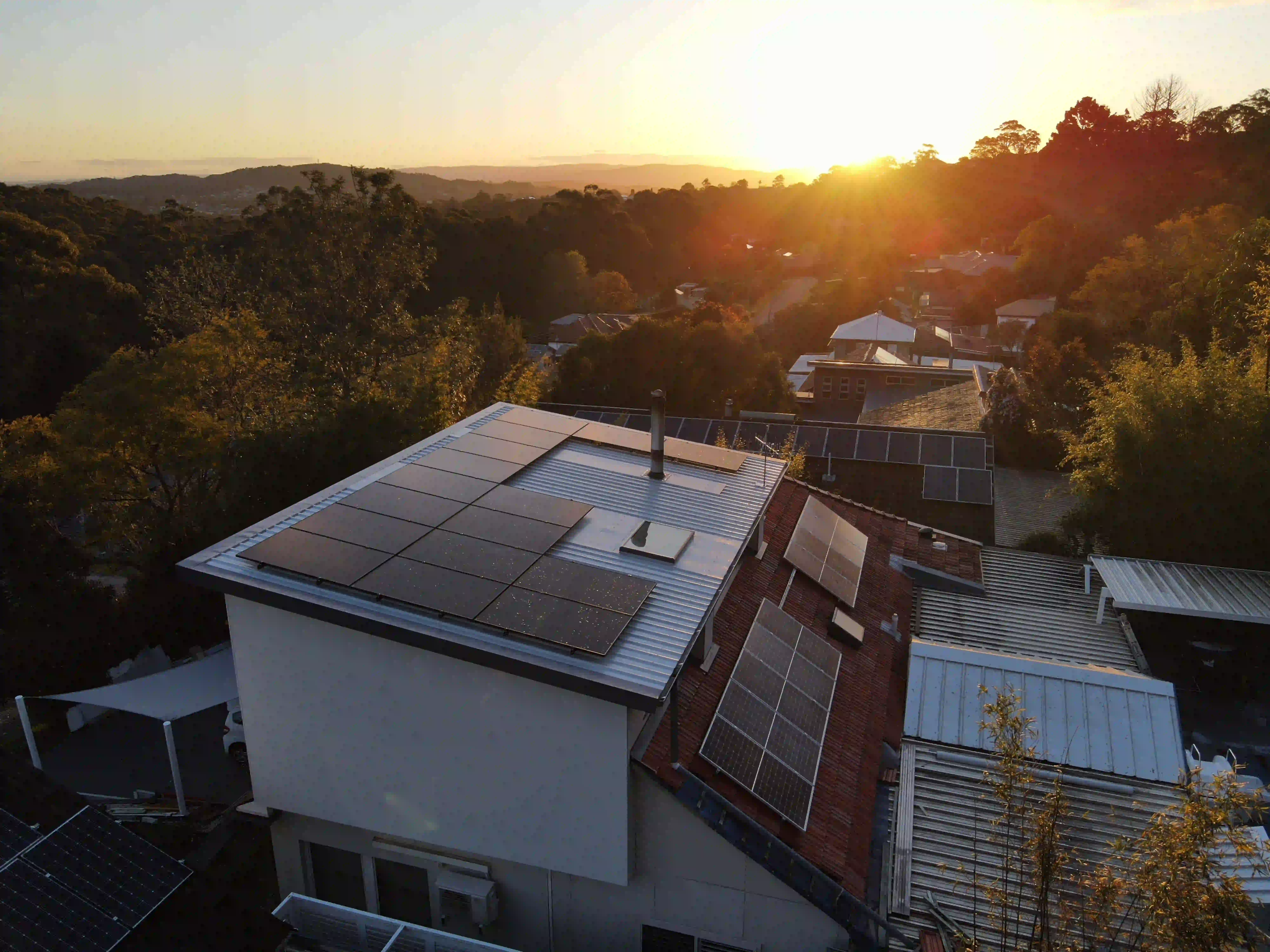 Aerial sunset view of a Newy Solar Co rooftop solar installation in Garden Suburb, Newcastle