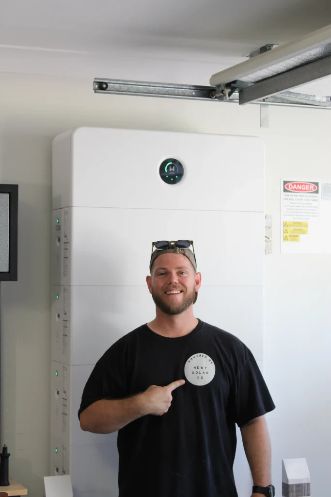 Newy Solar Co worker infront of Goodwe ESA battery, Newcastle NSW