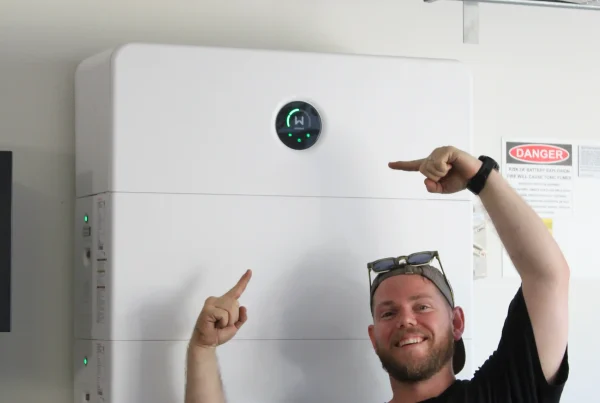 Newy Solar Co worker infront of Goodwe ESA battery, Newcastle NSW